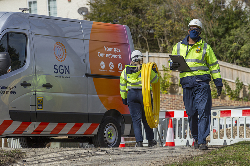 Two engineers with an SGN van