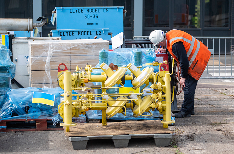 An engineer inspecting components being donated to Ukraine