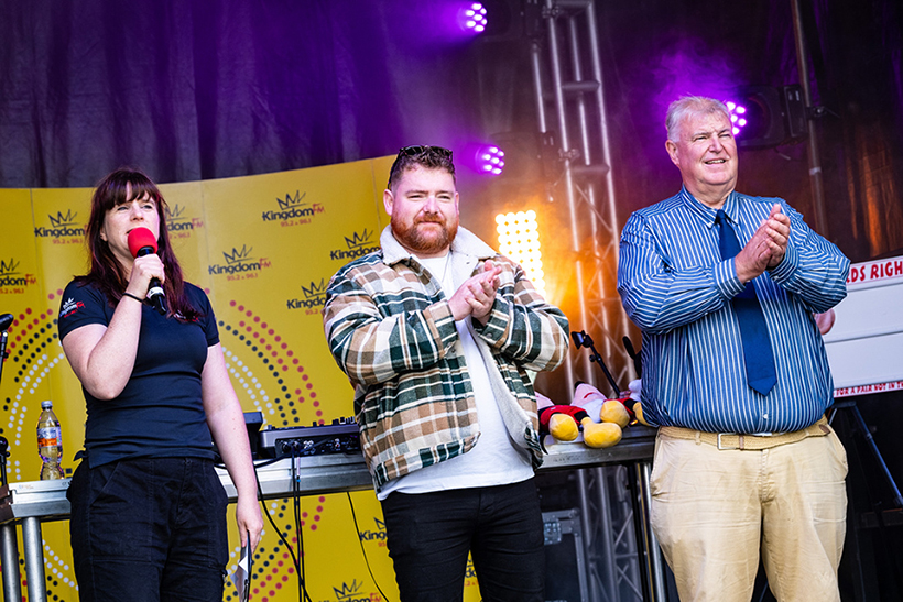 Three people on a stage