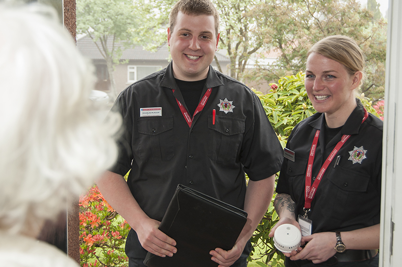 Two SFRS people carrying out a Home Safety Visit with elderly customer