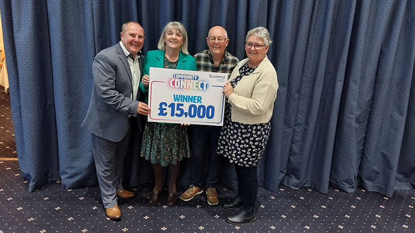 Mary Davis and the Barn Fork to Fork Community Garden team receive their prize at Scotmid holding the award