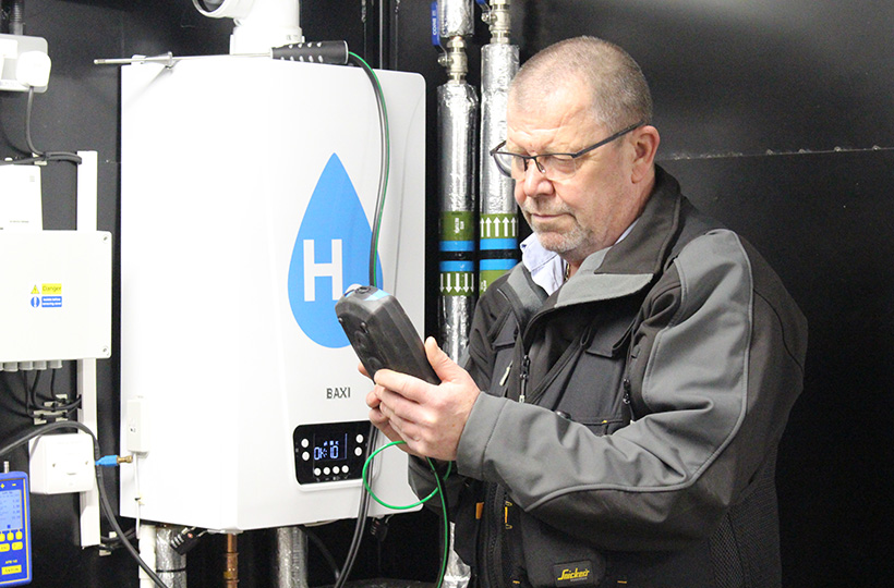 An engineer working on a hydrogen boiler