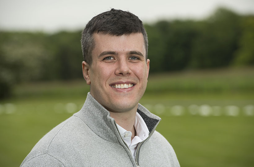 A headshot of a man in a rural setting