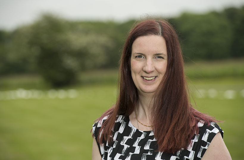 A headshot of a woman in a rural setting