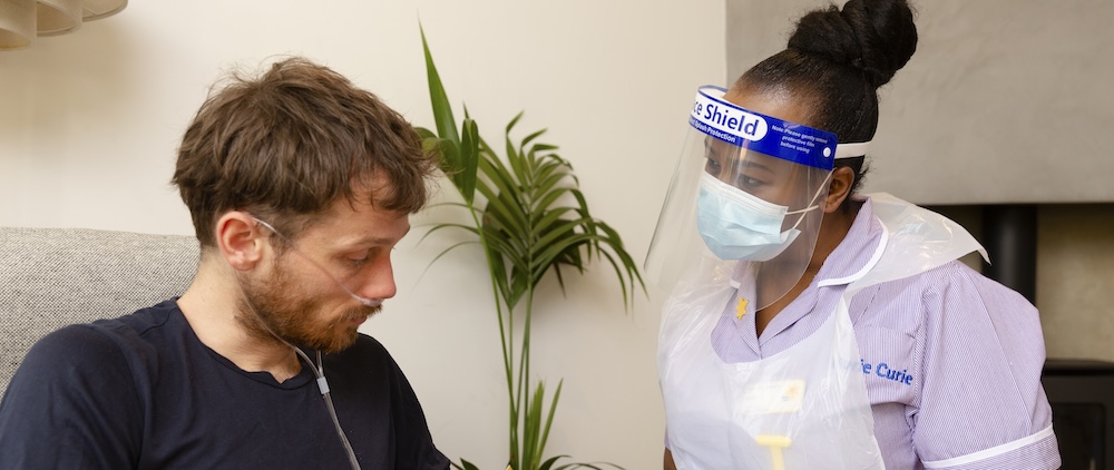 A Marie Curie nurse showing a patient some information