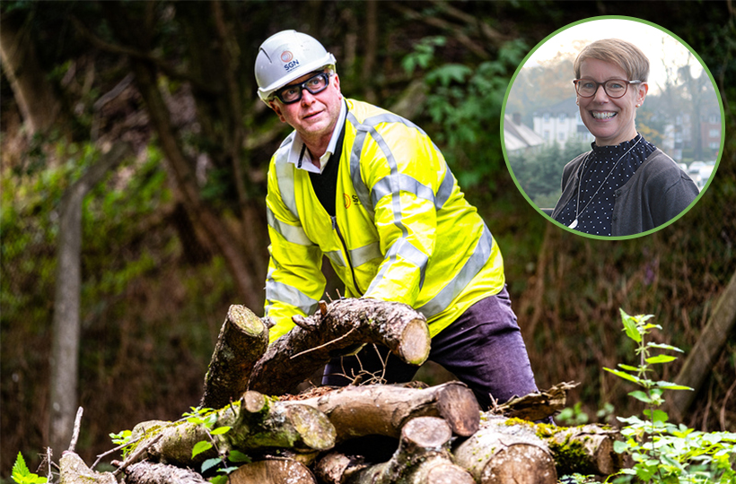 A man in SGN PPE moving logs in a wood as he looks into the distance, with a woman's smiling face in a circle cutout