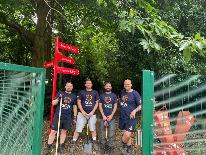 Our team of engineers stands at the front of Shenstone School's forest school after tidying the outdoor space