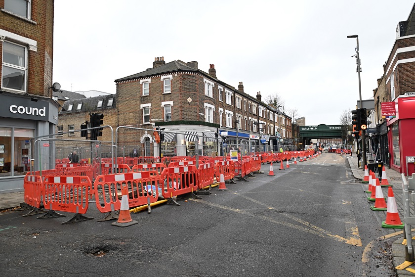 Long shot of the closure and work area along Garratt Lane with Earlsfield Station in the distance