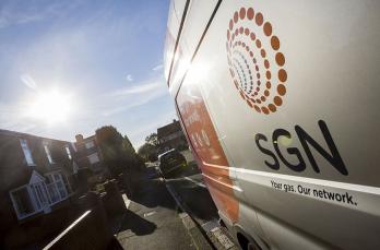 A gas van in a residential street with the sun shining 