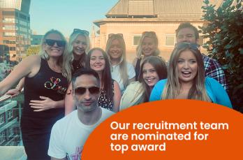 A happy group of nine people on a rooftop in the sunshine. Text: Our recruitment team are nominated for a top award