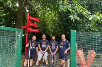 Our team of engineers stands at the front of Shenstone School's forest school after tidying the outdoor space